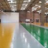 Factory floor painted in mid grey, yellow and green